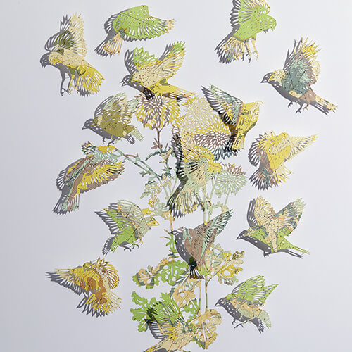 Seeing Through It by Claire Brewster. A paper sculpture of birds and foliage hand-cut from a vintage Geologic map of the San Lucas Dam Quadrangle, New Mexico, featuring yellow and green tones.