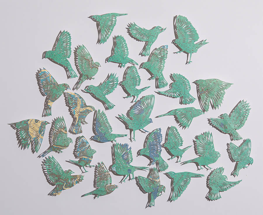 "Even I feel blue sometimes by Claire Brewster. A paper sculpture of a flock of birds hand-cut from a vintage Geologic map of the Centre Quadrangle, Kentucky."