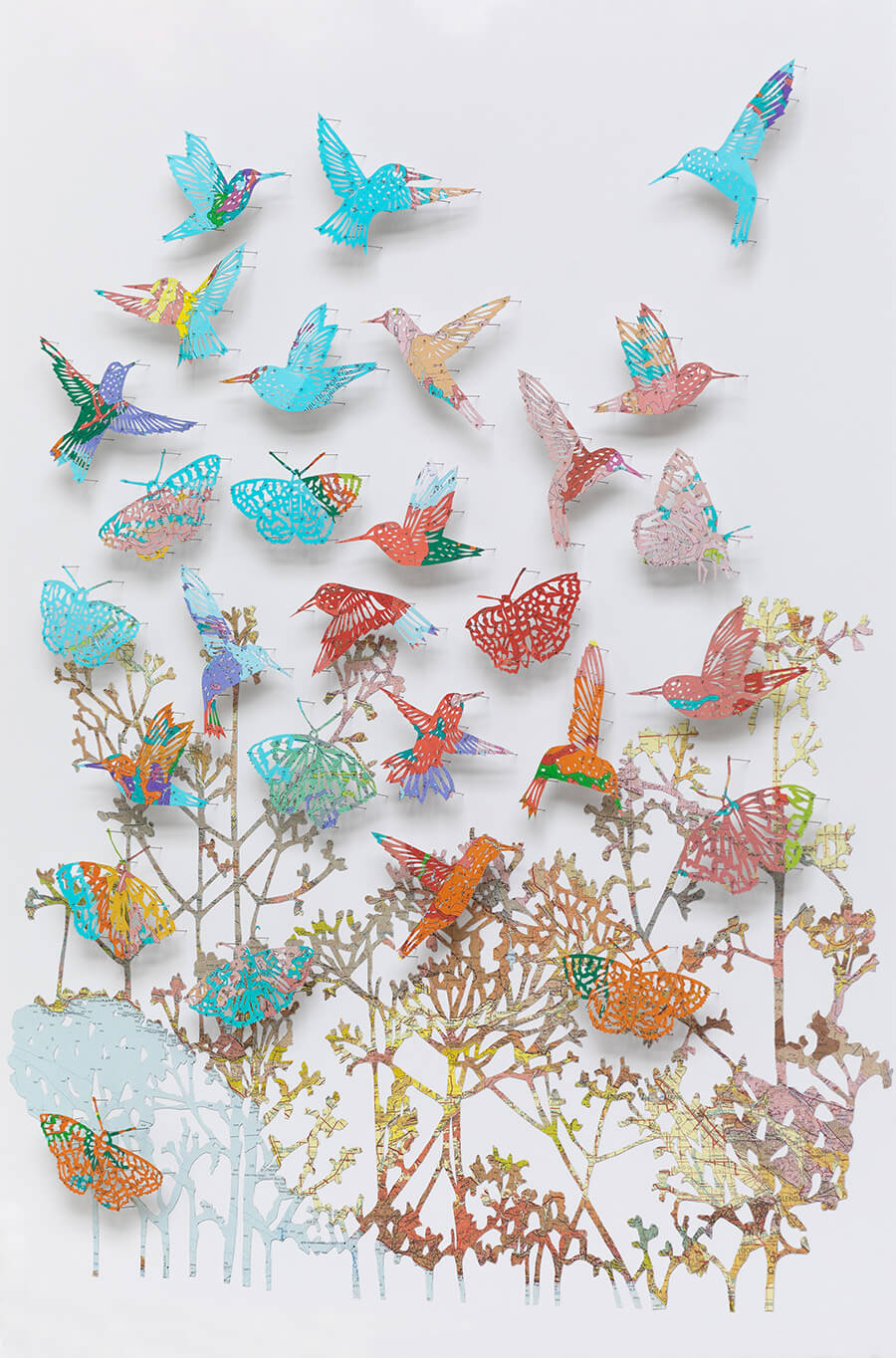 "We love life by Claire Brewster. A vibrant paper sculpture featuring hummingbirds and butterflies hand-cut from digitally printed vintage maps of California in bright blues, pinks, and oranges, commissioned for Stanford Children's Hospital."