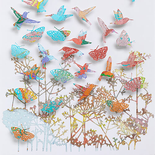 "We love life by Claire Brewster. A vibrant paper sculpture featuring hummingbirds and butterflies hand-cut from digitally printed vintage maps of California in bright blues, pinks, and oranges, commissioned for Stanford Children's Hospital."